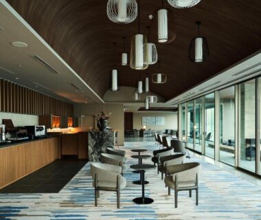 Spacious lounge with seating, pendant lights and floor-to-ceiling windows at Atami Izusan Karaku, Shizuoka, Chūbu
