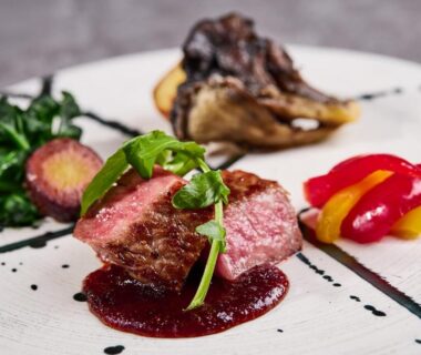 Sliced beef with sauce and colorful vegetable garnishes served in ryokan dining at Atami Izusan Karaku Shizuoka