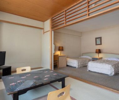Tatami seating area with low table and twin beds at Atami New Fujiya Hotel in Shizuoka, Chūbu, Japan