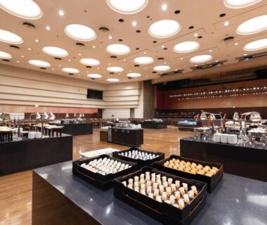 Banquet-style buffet tables with assorted dishes in a large dining hall at Atami New Fujiya Hotel, Shizuoka