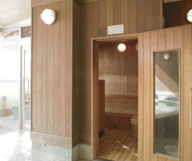 Interior wooden sauna with bench, glass door and tiled entrance at Atami Onsen Sakuraya Shizuoka