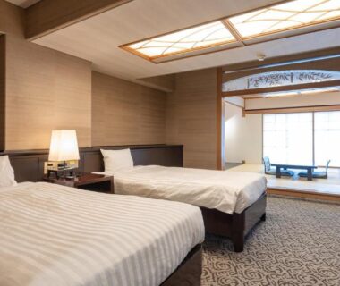 Twin beds, tatami seating and shoji doors at Atami Season Hotel in Shizuoka, Chūbu Japan