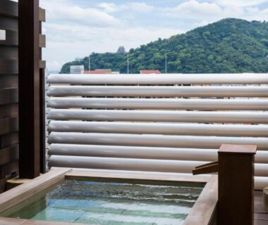 Wooden balcony soaking tub with mountain view at Atami Season Hotel in Shizuoka