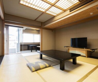 Traditional tatami room with low table, cushions and balcony at Atami Season Hotel Shizuoka
