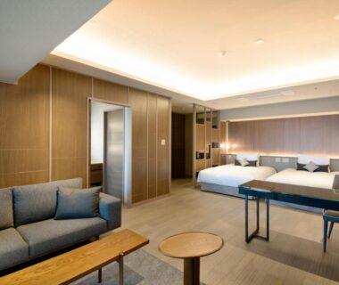 Modern twin bedroom with sofa and wooden paneling at Atami Sekaie, Shizuoka, Chubu