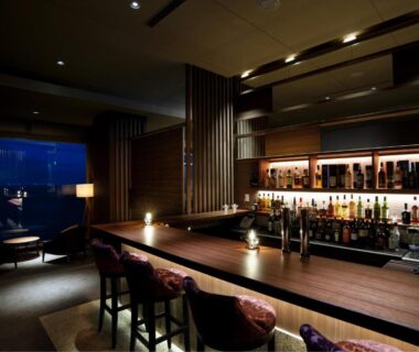 Intimate wooden bar counter with stools at Atami Sekaie, Shizuoka