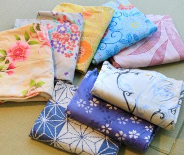 Folded floral yukata arranged on tatami mat at Atami Tensui, Shizuoka, Chūbu, Japan