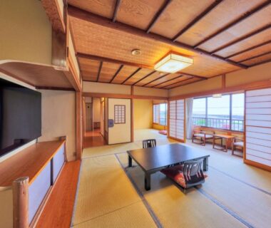Tatami room with low table, shoji screens and balcony seating at AtamiOnsen Nagahamaen in Shizuoka