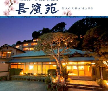 Warmly lit ryokan exterior with entrance and garden tree at AtamiOnsen Nagahamaen, Shizuoka, Chubu