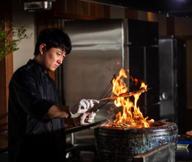 Chef grilling over open flame in ryokan kitchen at Atarayo Nishiizu Onsen Shizuoka