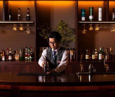 Bartender preparing drink behind polished bar at Atarayo Nishiizu Onsen Shizuoka