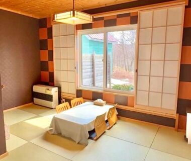 Bright tatami room with low table, shoji screens and wooden ceiling at Auberge Ninguruforet, Hokkaidō