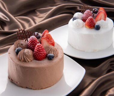 Two berry-topped cakes on plates at Aura Tachibana in Kanagawa, Kantō, Japan