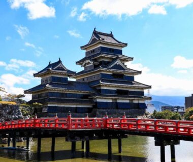 Black timber castle with red bridge near Awanoyu in Nagano, Chūbu Japan