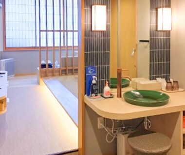 Interior showing tatami flooring, wash basin, shoji screens and seating in Ayameya Ryokan room in Gunma