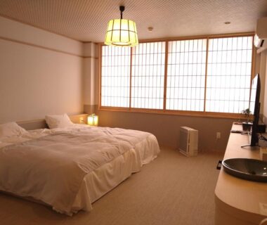 Twin beds with shoji screens and soft lighting at Ayameya Ryokan in Gunma, Kantō