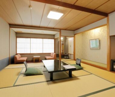 Traditional tatami room with low table, cushions, window seating and shoji at Azumakan, Fukushima