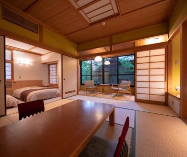 Tatami room with low table, shoji screens and garden view at Baien in Ōita, Kyūshū, Japan
