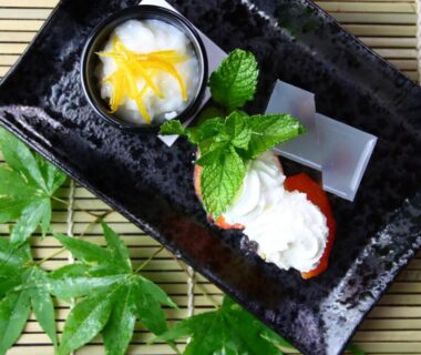 Japanese desserts with mint garnish on black ceramic plate and bamboo mat at Baigetsu Ryokan, Nagano