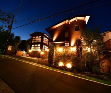 Lit exterior of Balinese onsen ryokan Hakone Airu along a quiet street in Kanagawa, Japan