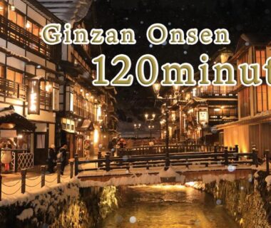 Riverside wooden ryokans lit at night in Ginzan Onsen near Bankokuya, Yamagata