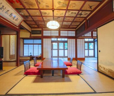 Traditional tatami room with low table, floor cushions, shoji screens and decorated ceiling at Bansuirou Fukuzumi in Kanagawa