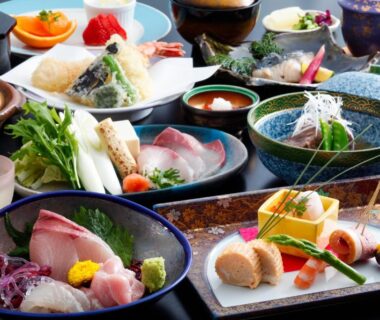 Traditional multi-course meal spread with sashimi and vegetable side dishes at Bekkan Yosanoso Kyoto