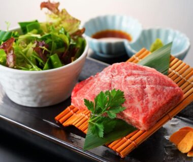 Marbled raw beef on bamboo mat with salad and dipping sauce at Beppu Fuga, Ōita, Japan
