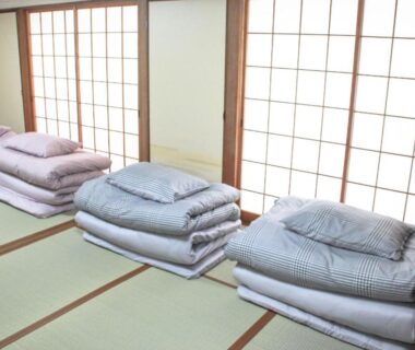 Stacked futons on tatami beside shoji screens at Beppu Kannawa Onsen HIROMIYA, Ōita, Kyūshū