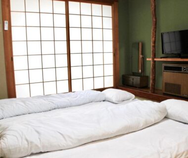 Futon on tatami with shoji screens and wooden TV cabinet at Beppu Kannawa Onsen HIROMIYA, Oita