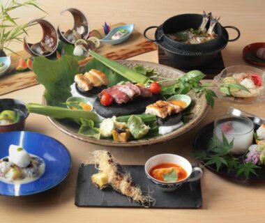 Assorted traditional Japanese dishes and sushi arranged on a table at Beppu Nagomitsuki, Ōita