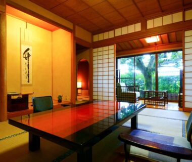 Tatami room with low lacquer table, shoji screens and garden view at Beppu Showaen in Ōita, Kyūshū