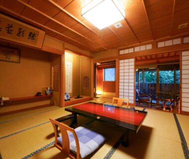 Traditional tatami room with low table, shoji screens and garden view at Beppu Showaen in Oita