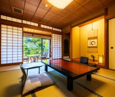 Traditional tatami room with low table, shoji screens and garden view at Beppu Showaen in Oita, Kyushu