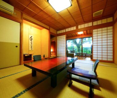 Tatami room with low table, shoji screens and garden view at Beppu Showaen, Ōita
