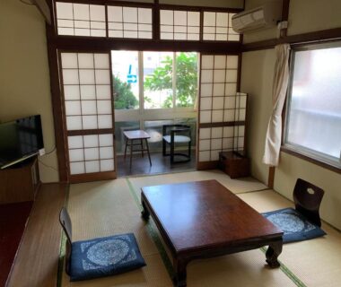 Traditional tatami room with low table and shoji screens at Beppu no Oyado Kagaya in Ōita, Kyūshū
