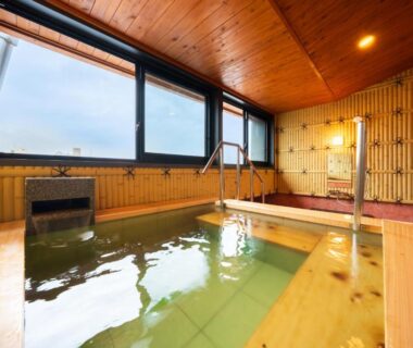 Indoor wooden onsen bath with windows at BeppuOnsen Hotel Sansenkaku, Ōita, Kyūshū