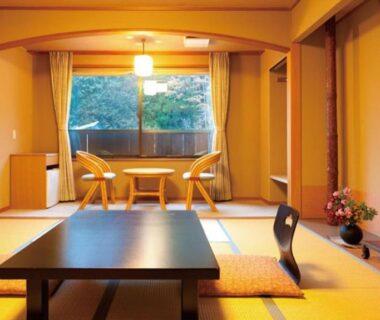 Japanese tatami room with low table and floor chairs at Bergtour Marukita in Chūbu, Nagano, Japan