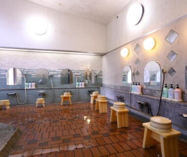 Communal bathing room with stools, faucets and mirrors at Besshoonsen Nanjyo Ryokan, Nagano, Chūbu