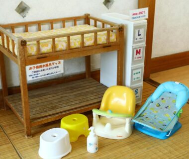 Wooden baby changing table with plastic bath seats and potty stools on tatami at Besshoonsen Nanjyo Ryokan in Nagano