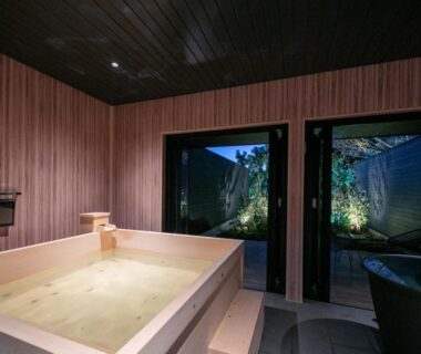 Wooden soaking tub with garden view at Bettei Fujiya, Hiroshima