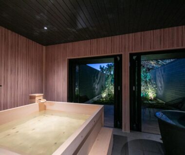 Indoor wooden bath opening to garden courtyard at Bettei Fujiya, Hiroshima