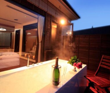 Wooden terrace with bathtub and bottle opening onto tatami room at dusk, Bettei Koyoi, Kanagawa