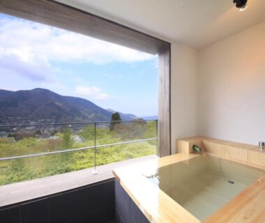 Indoor wooden soaking tub with large window overlooking mountains at Bettei Koyoi, Kanagawa, Kantō, Japan