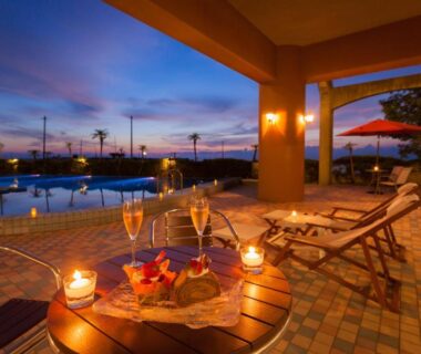 Evening poolside seating with candles, glasses and loungers at Boyokaku, Okinawa Japan