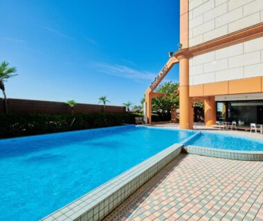 Outdoor tiled pool and lounge area at Boyokaku ryokan, Kumamoto, Kyushu under clear blue sky