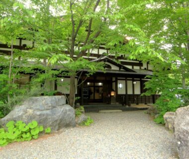 Tree-lined gravel path leading to traditional ryokan entrance at Bunanoyado Koase in Niigata, Chūbu region