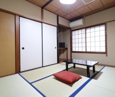 Tatami room with low table, zabuton cushion and shoji screens at Business Ryokan Iroha in Gifu, Chūbu, Japan