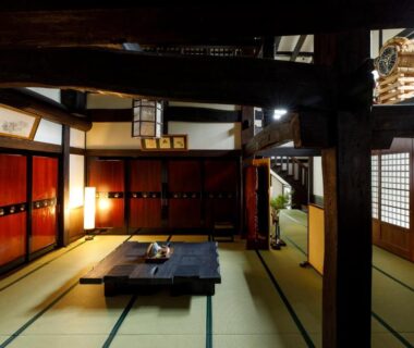 Tatami room with low table, shoji screens and exposed beams at Busuitei, Chūbu Gifu Japan