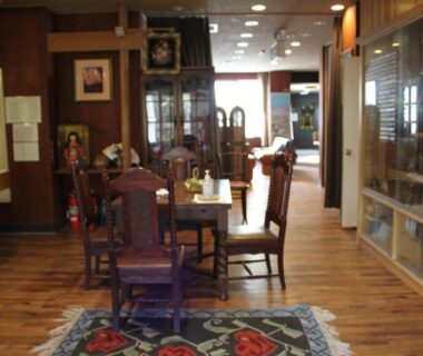 Cozy wooden seating area and display cabinets at Cafe Cerisier栖里時絵 in Niigata, Chūbu, Japan